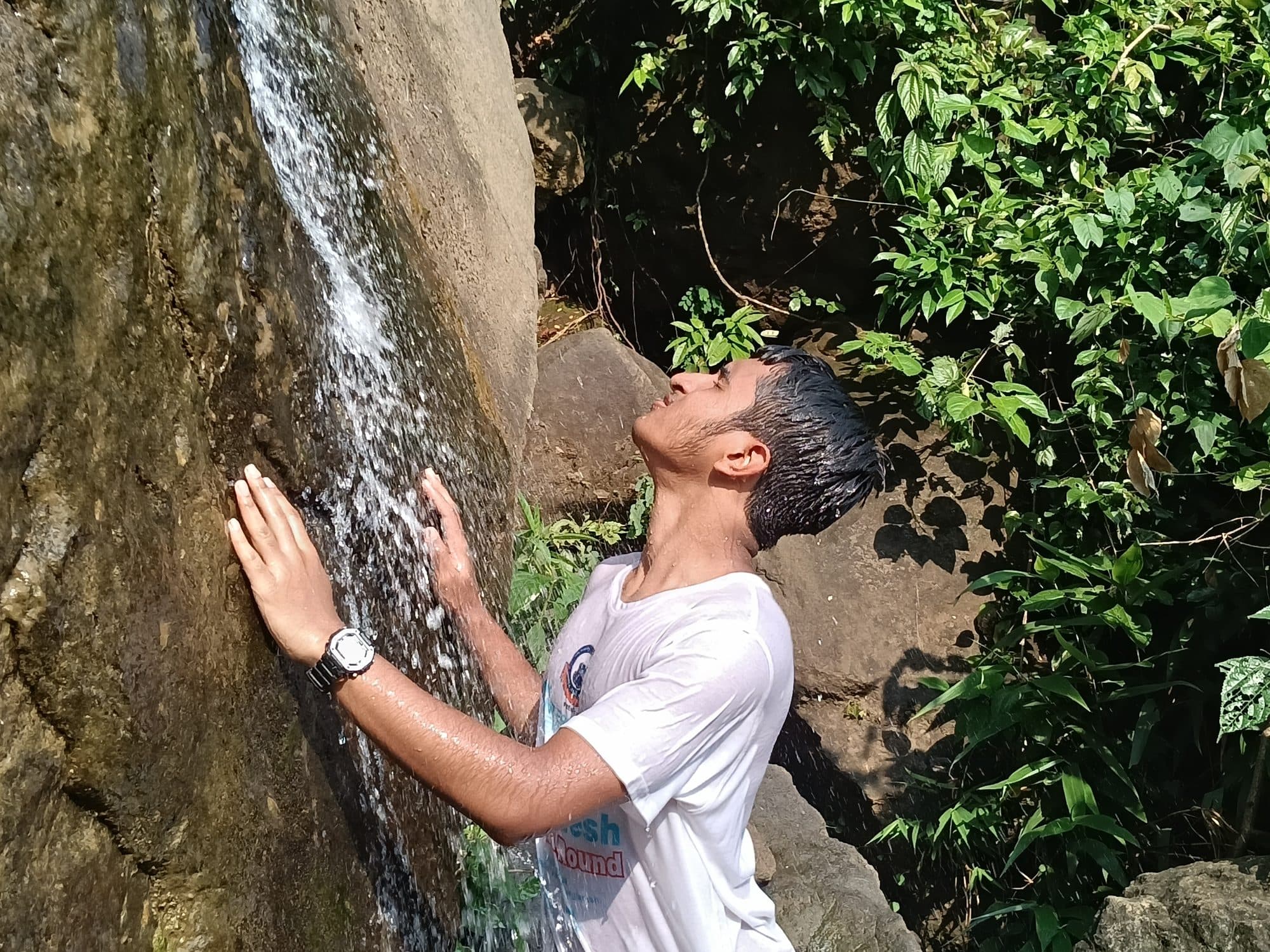 Mohammad Nasir under a small waterfall in Sylhet