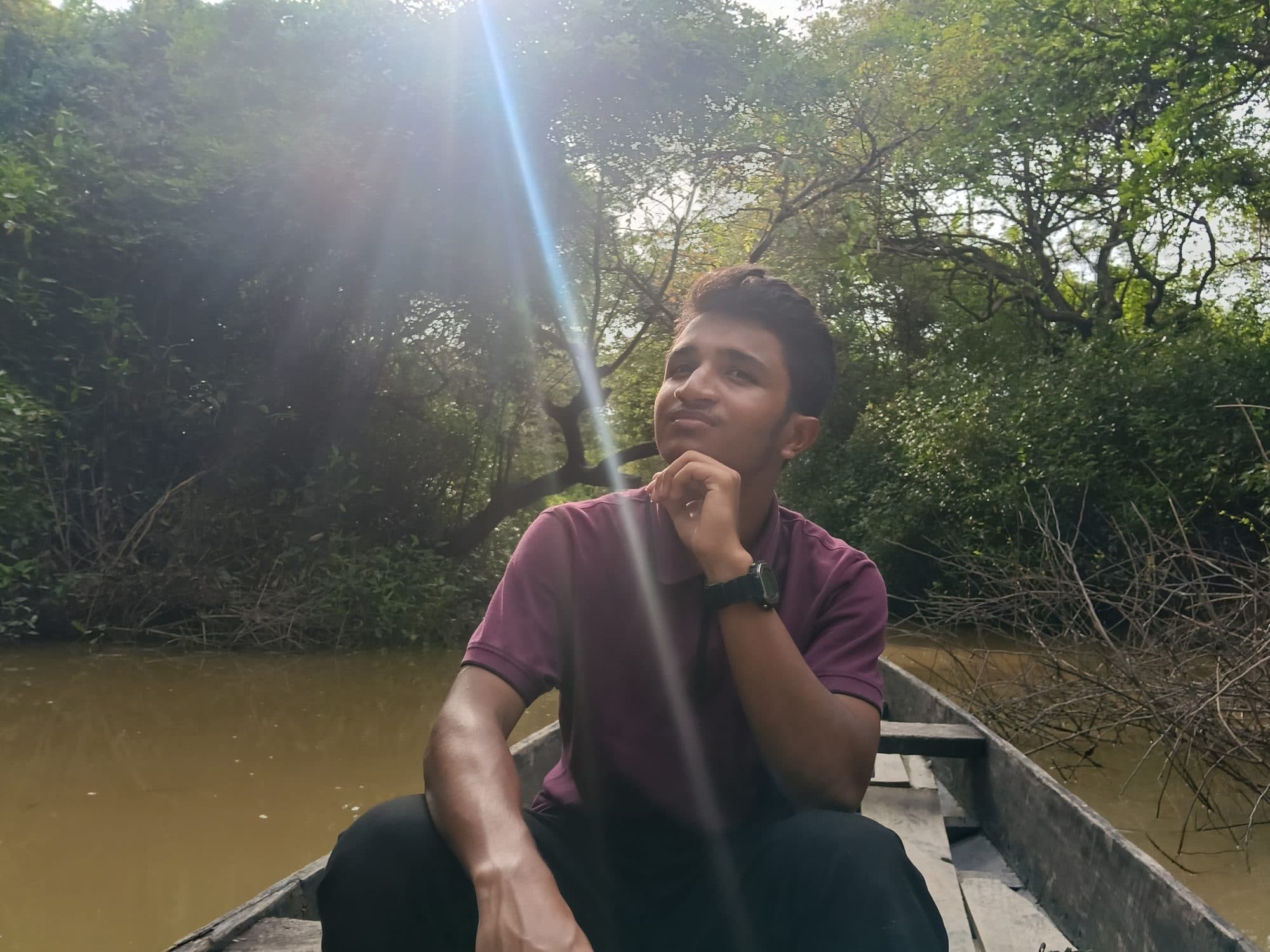 Mohammad Nasir in a boat at golden hour in Sylhet
