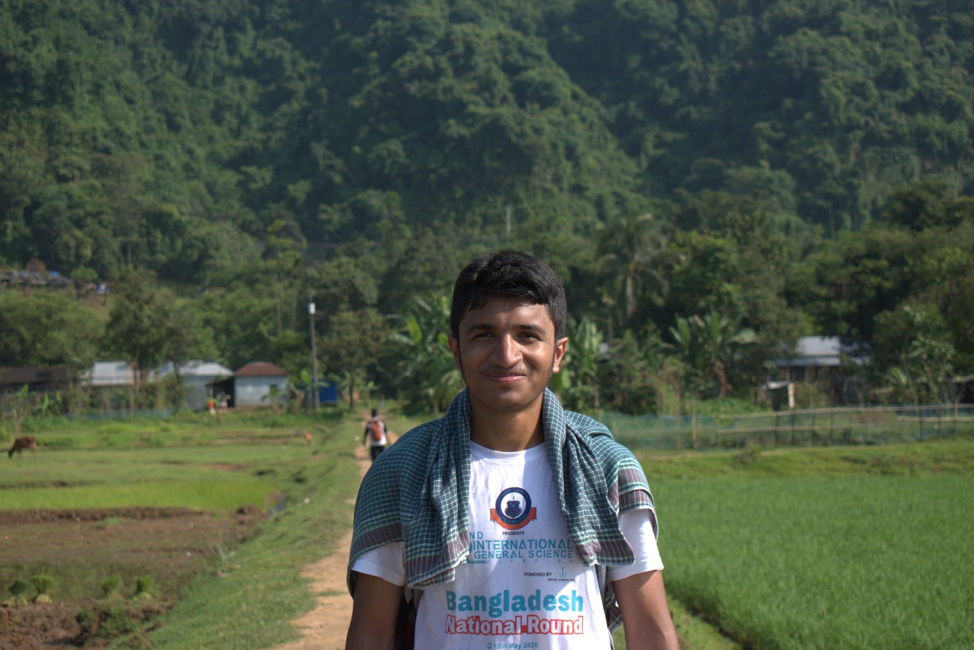 Mohammad Nasir smiling in the paddy fields of Sylhet