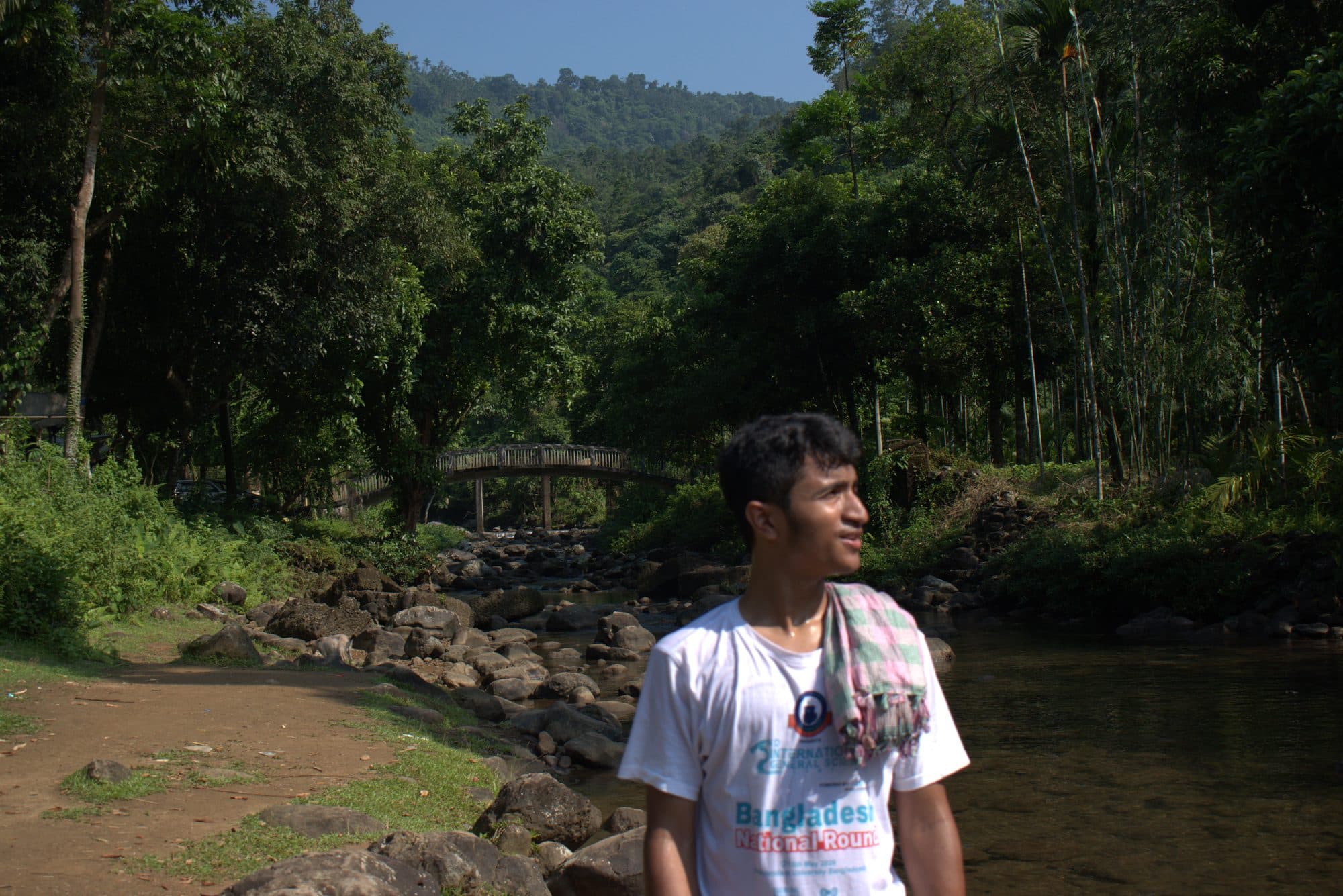 Mohammad Nasir by a stream in a Sylhet forest
