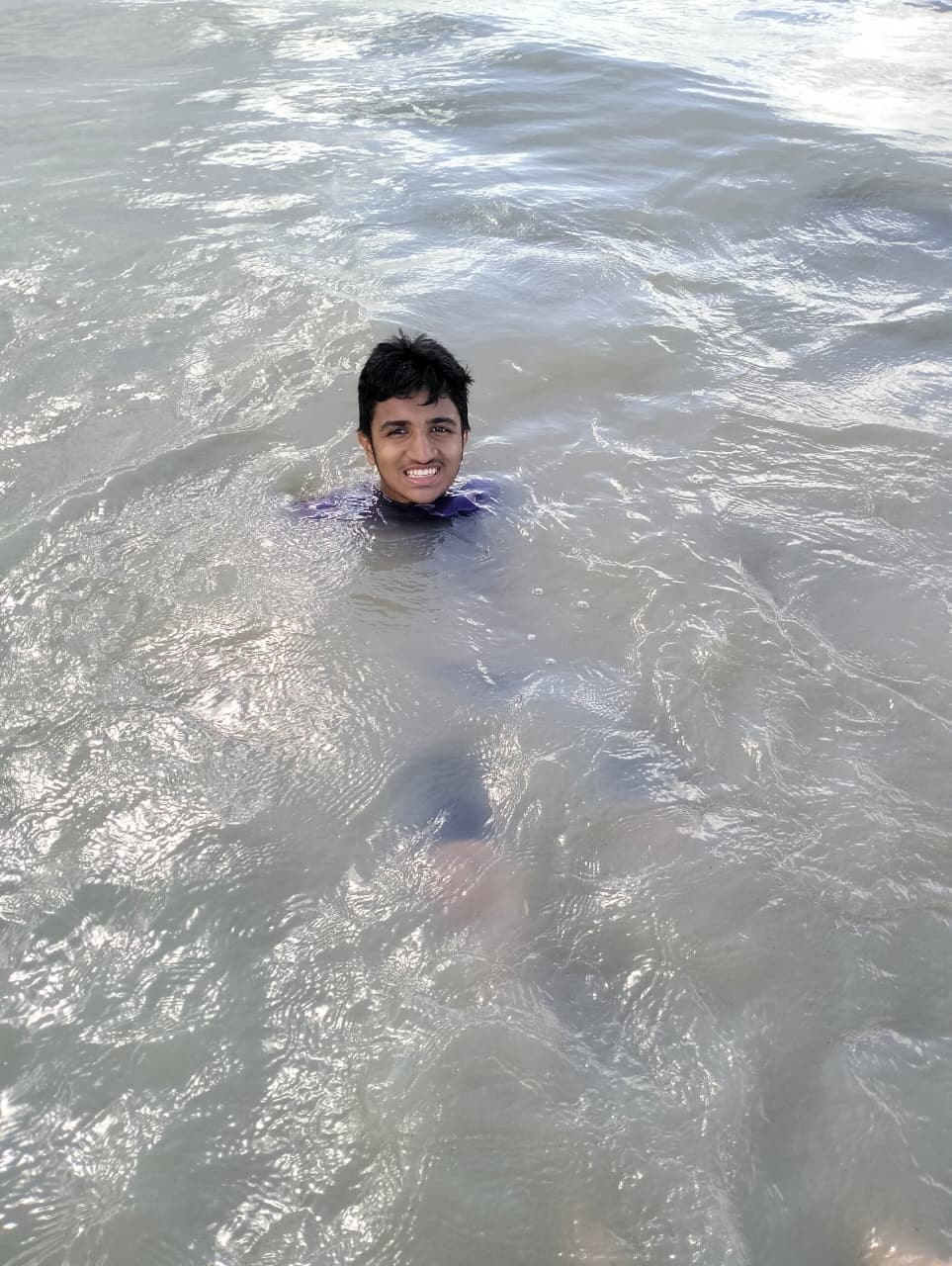 Mohammad Nasir swimming in the sea at Kuakata