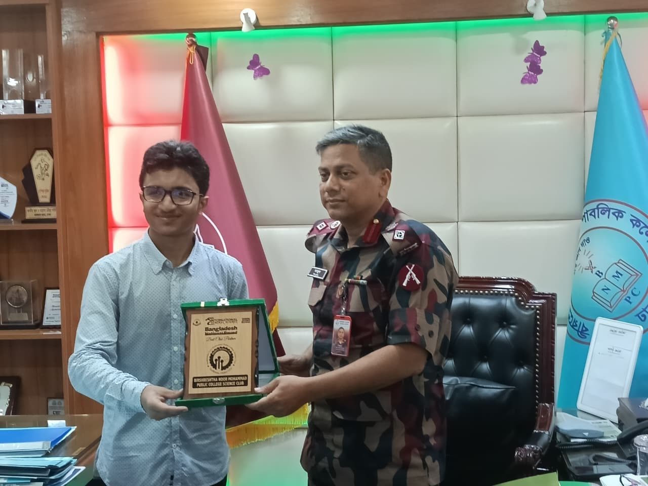 Mohammad Nasir presenting a crest to an officer