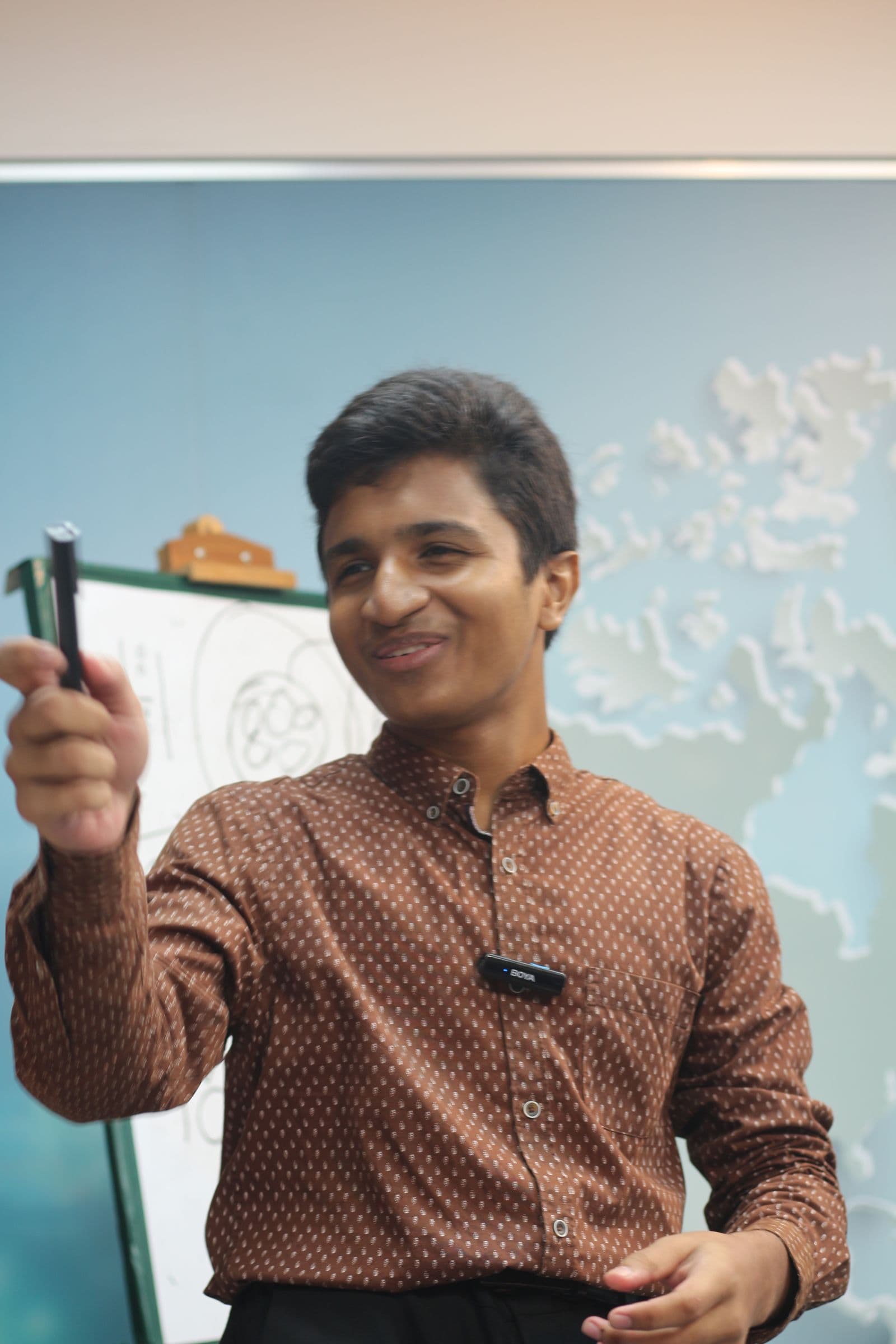 Mohammad Nasir explaining a science problem at a whiteboard