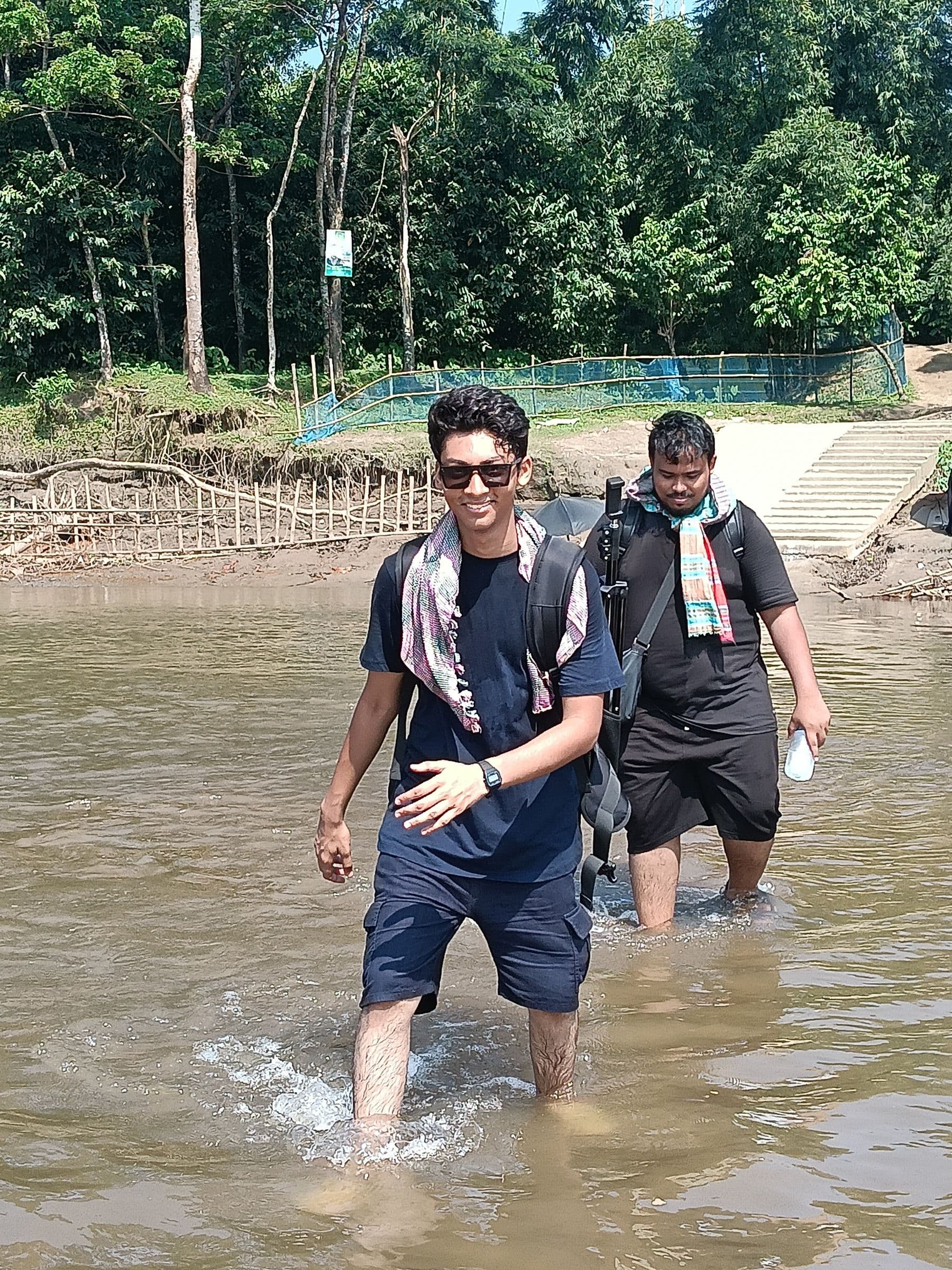 Wading through a river on the Sylhet border hike