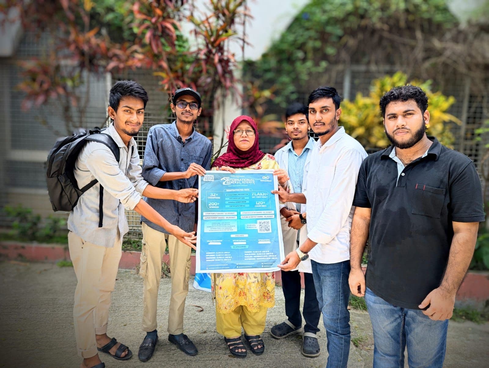 Campaign team with a school principal holding the IGSO poster