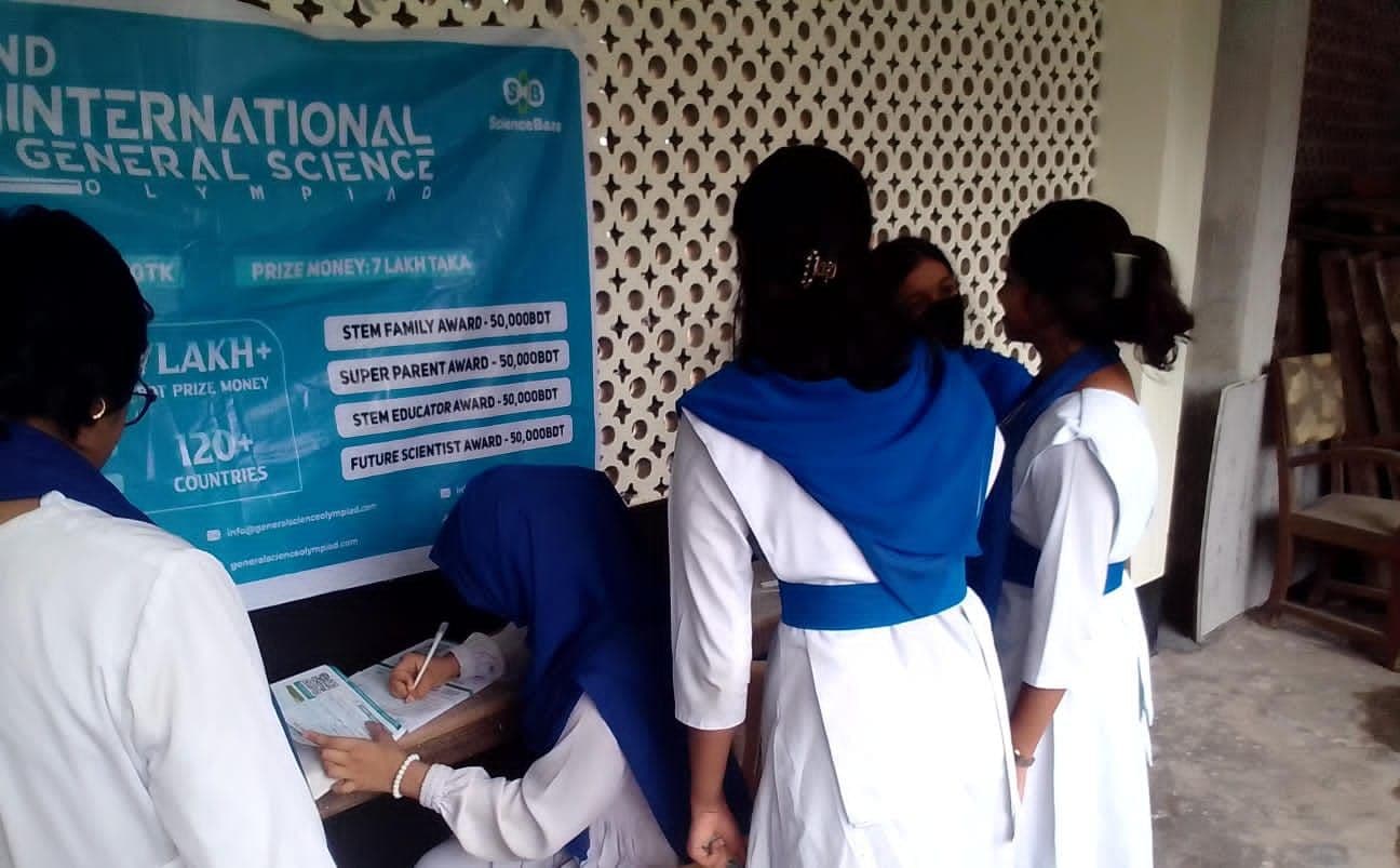 Schoolgirls reading the IGSO poster