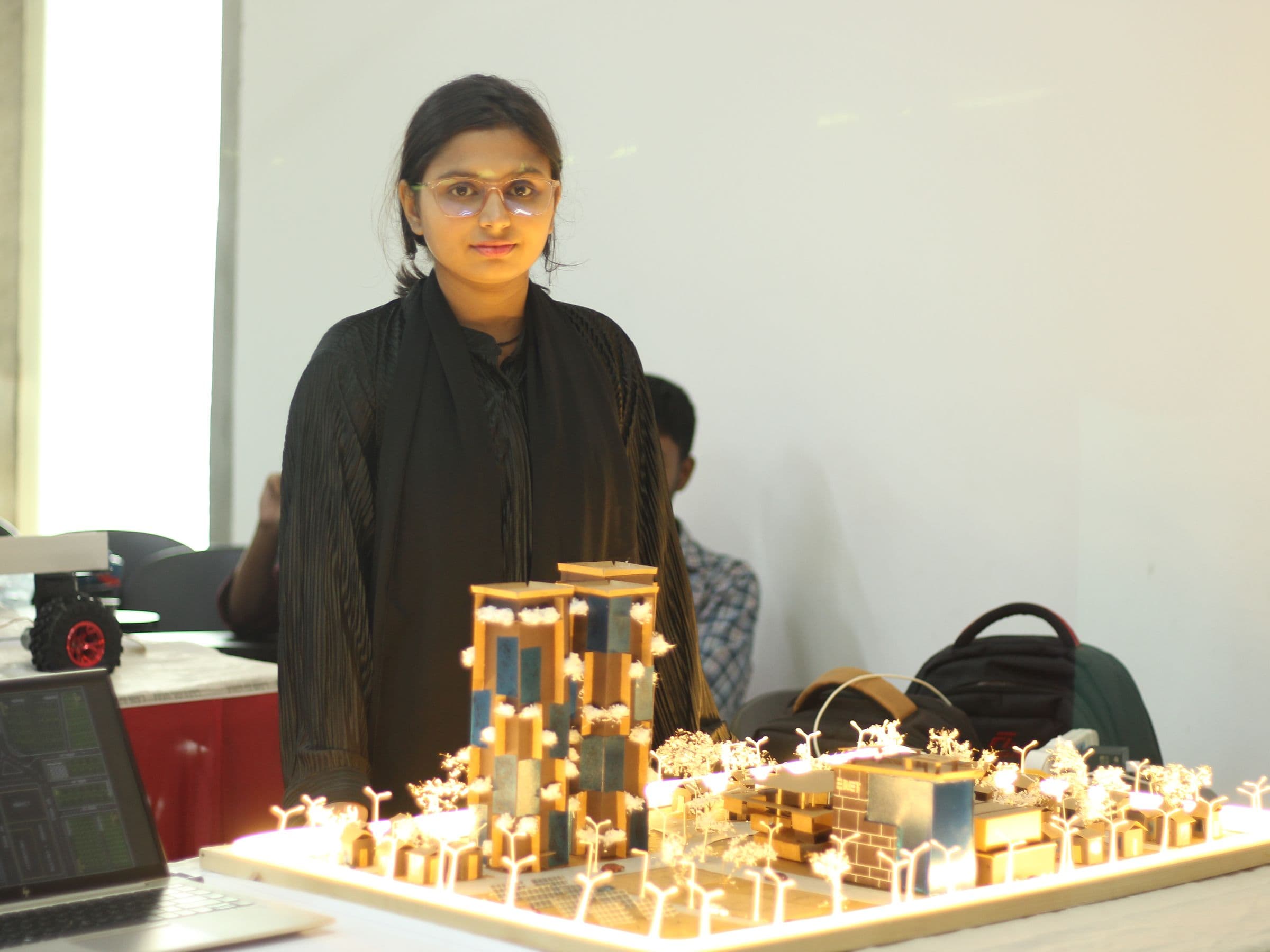 A participant presenting her illuminated project model