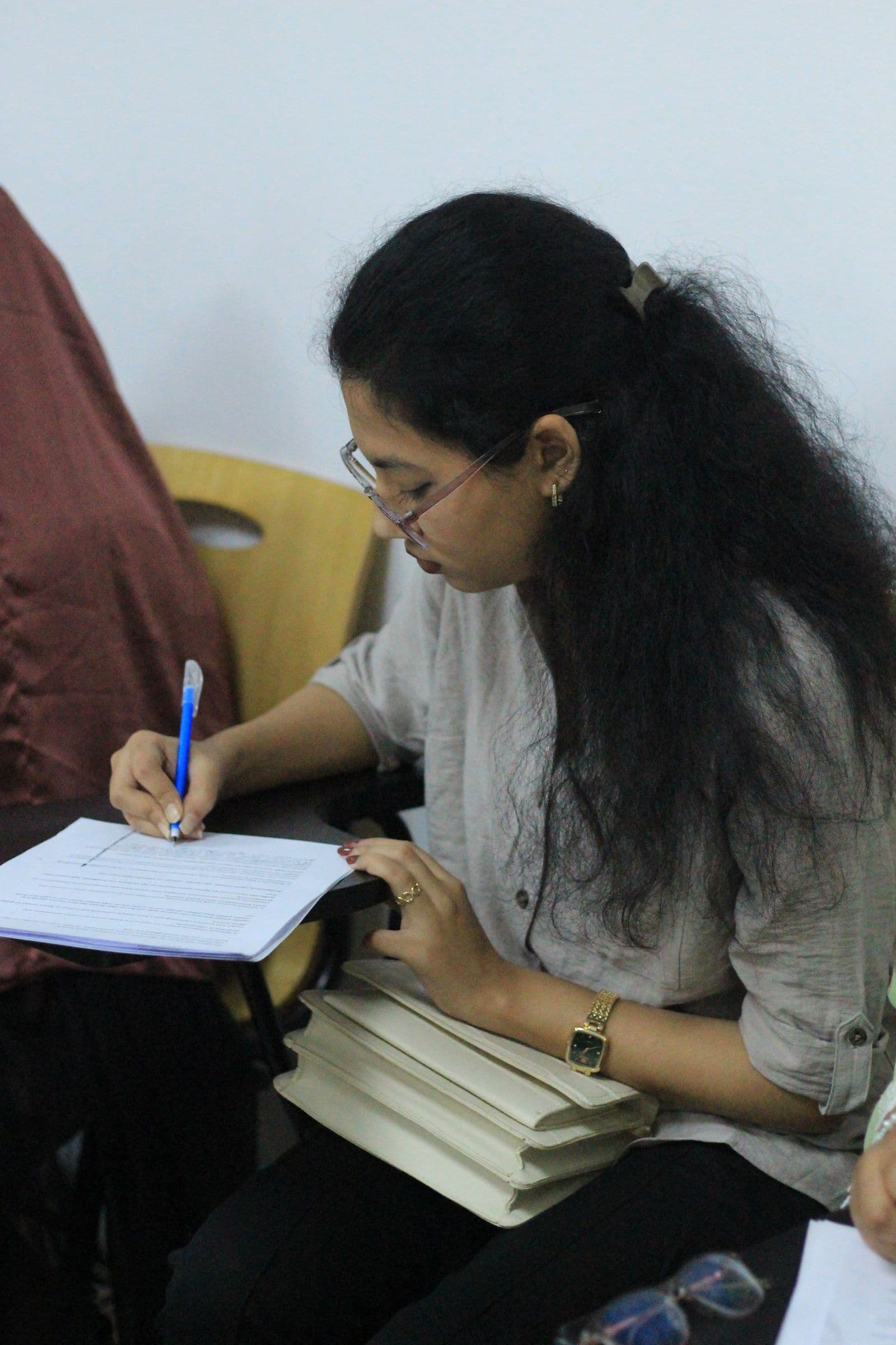 A participant writing her answers at the national round