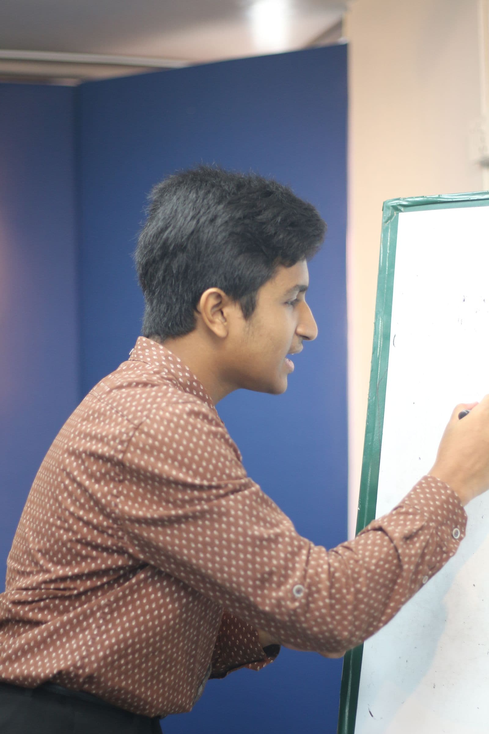 Mohammad Nasir drawing on a whiteboard at Science Discussion
